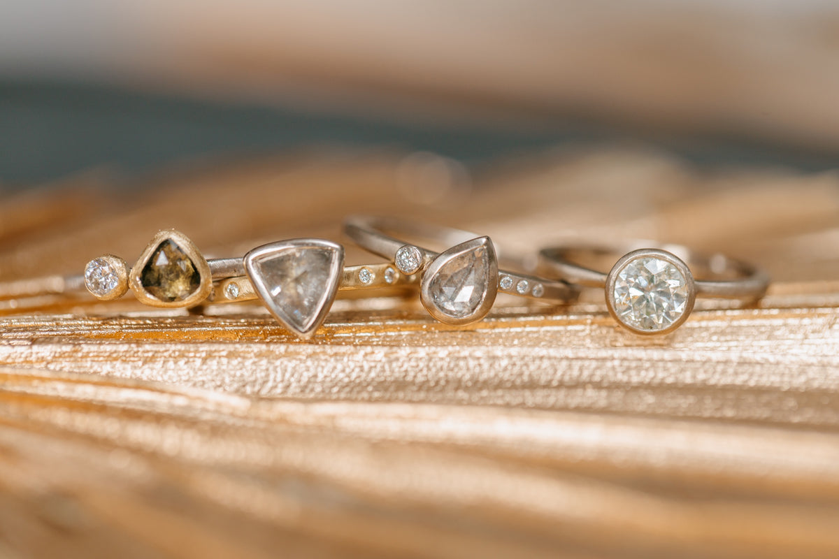 four custom hand made diamond engagement rings crafted by Kate Maller Jewelry in Denver Colorado