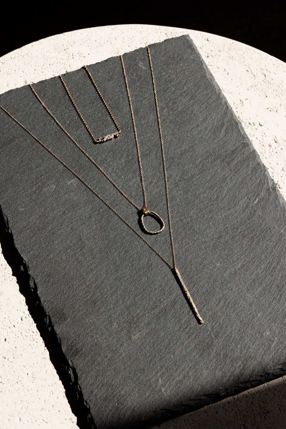 trio of custom gold handmade necklaces designed by Kate Maller Jewelry in Denver Colorado